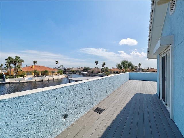 wooden deck featuring a water view