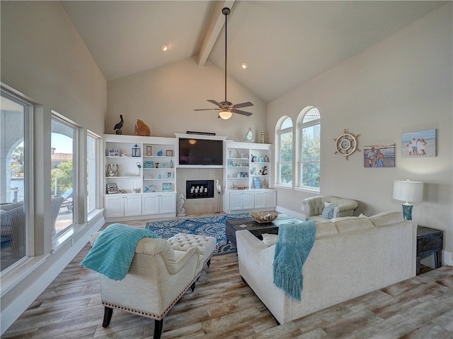 living room featuring beam ceiling, hardwood / wood-style flooring, and plenty of natural light