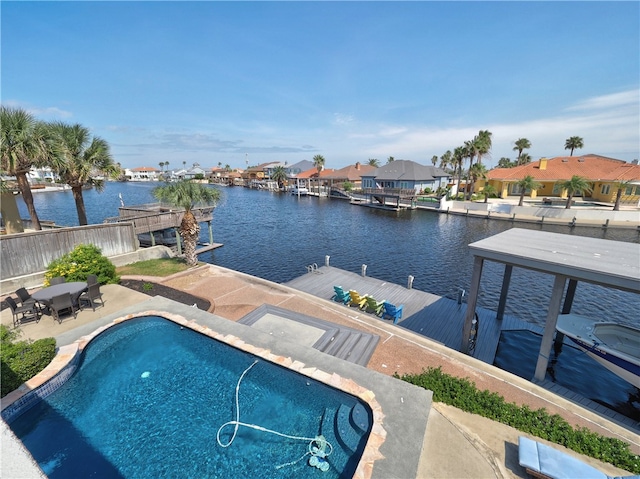 view of swimming pool featuring a patio and a water view