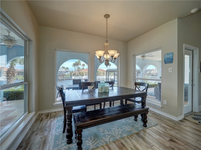 dining space with a notable chandelier and light hardwood / wood-style flooring