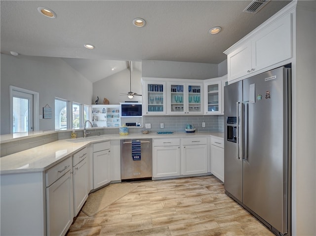 kitchen featuring tasteful backsplash, sink, white cabinetry, and stainless steel appliances