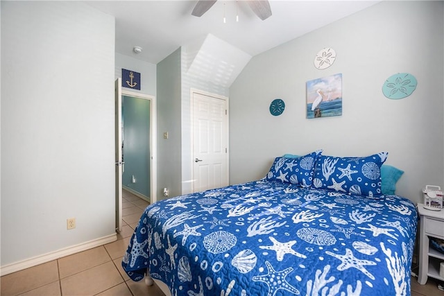 tiled bedroom featuring lofted ceiling, ceiling fan, and baseboards