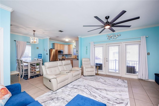 living area featuring ceiling fan with notable chandelier, visible vents, crown molding, and light tile patterned flooring