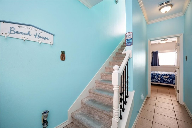 staircase with baseboards, ornamental molding, visible vents, and tile patterned floors