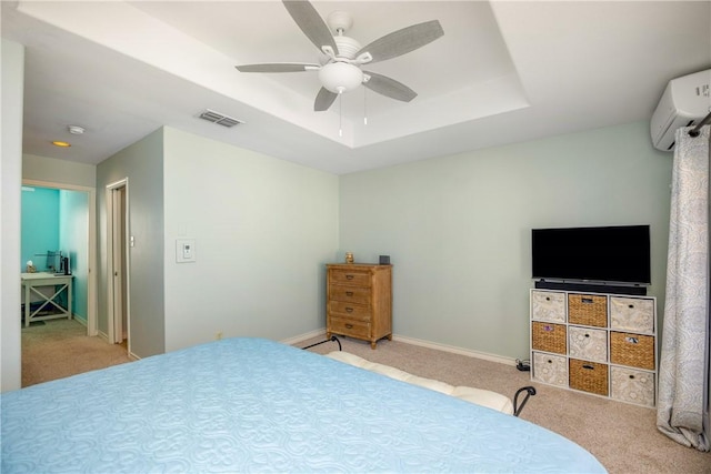 bedroom featuring baseboards, visible vents, a raised ceiling, light colored carpet, and an AC wall unit