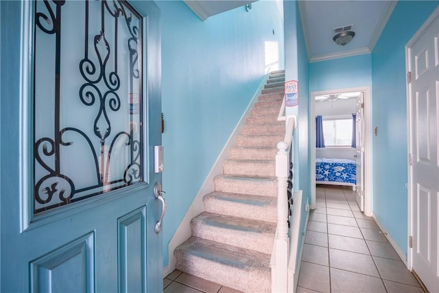 interior space with stairs, ornamental molding, visible vents, and baseboards