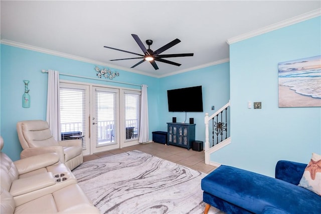 living area with stairs, ceiling fan, tile patterned flooring, and crown molding