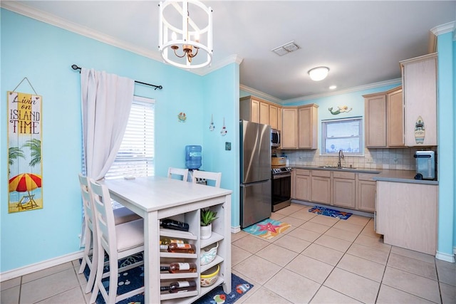 kitchen with light tile patterned floors, appliances with stainless steel finishes, backsplash, and ornamental molding