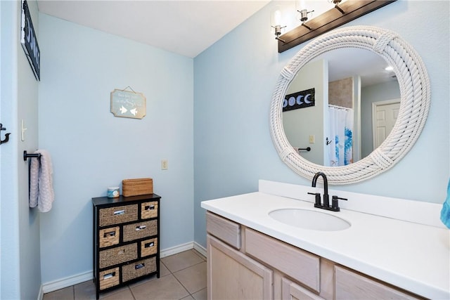 full bath featuring vanity, baseboards, and tile patterned floors