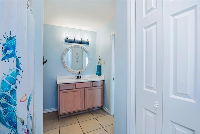 bathroom featuring baseboards, a shower with curtain, vanity, and tile patterned floors