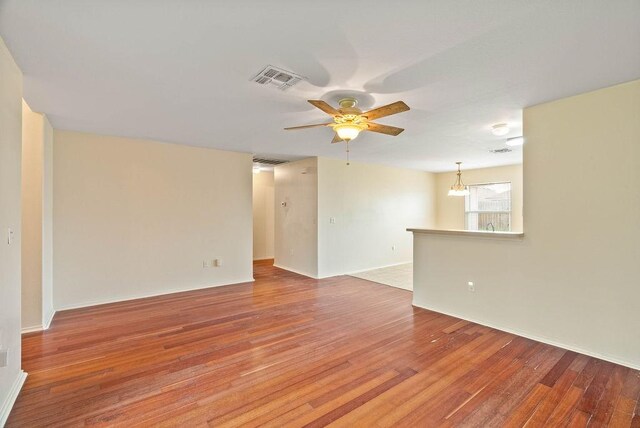 1606 W Nelson Ave, Aransas Pass, TX 78336 - unfurnished room with ceiling fan, light wood-style floors, and a chandelier