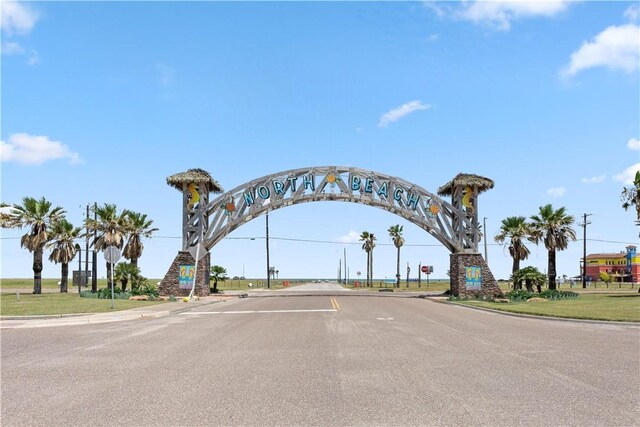 3938 Surfside Blvd Unit 3118, Corpus Christi, TX 78402 - view of asphalt road with curbs, traffic signs, and a gate