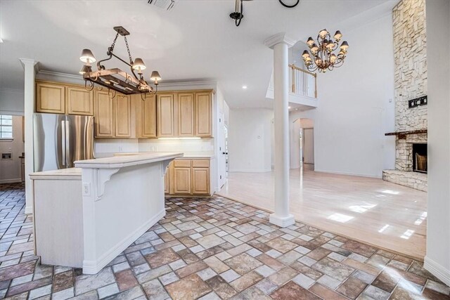 6302 Grandvilliers Dr, Corpus Christi, TX 78414 - kitchen with a chandelier, freestanding refrigerator, light countertops, light brown cabinets, and a kitchen island