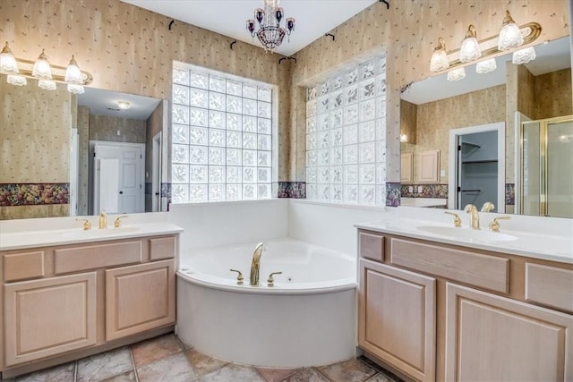 6302 Grandvilliers Dr, Corpus Christi, TX 78414 - full bath featuring wallpapered walls, two vanities, a stall shower, and a garden tub