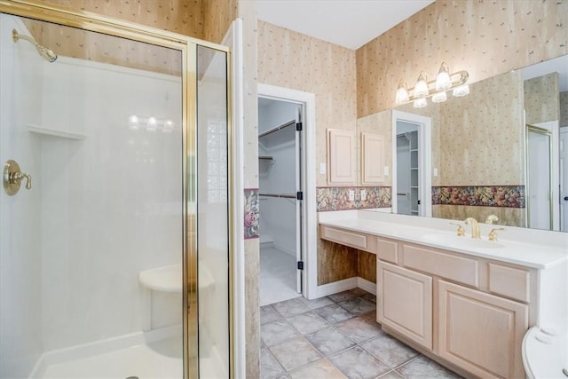 6302 Grandvilliers Dr, Corpus Christi, TX 78414 - full bathroom featuring wallpapered walls, a shower stall, a walk in closet, and vanity