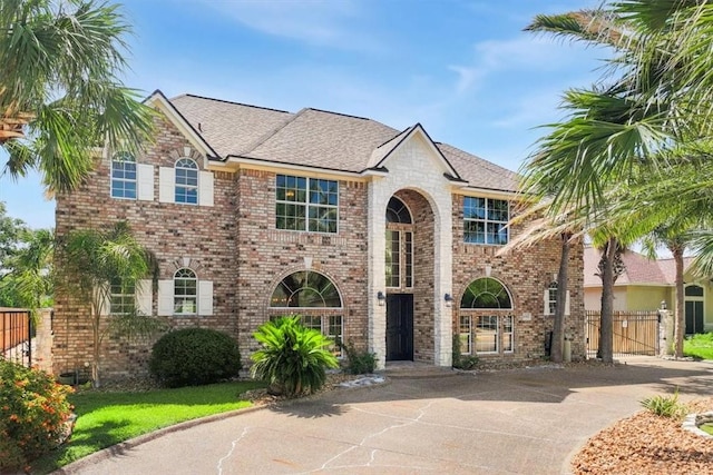 6302 Grandvilliers Dr, Corpus Christi, TX 78414 - view of front facade featuring brick siding, concrete driveway, and a shingled roof