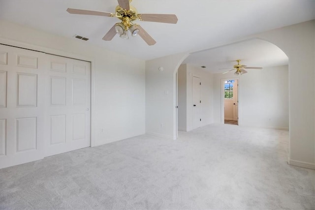 6302 Grandvilliers Dr, Corpus Christi, TX 78414 - unfurnished living room featuring arched walkways, ceiling fan, and carpet floors