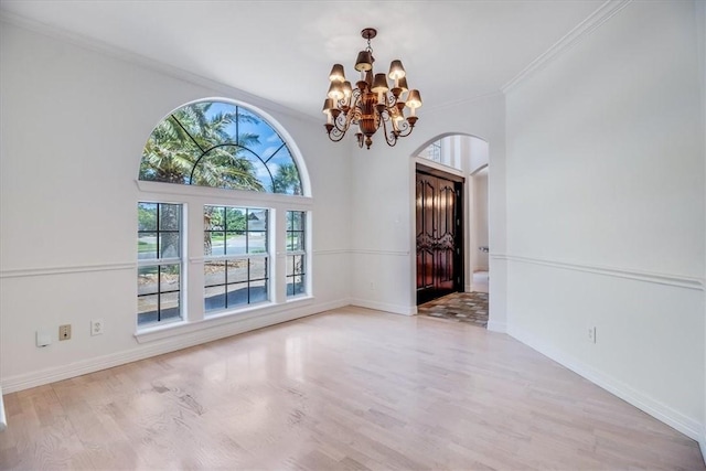 6302 Grandvilliers Dr, Corpus Christi, TX 78414 - entryway featuring a chandelier, arched walkways, crown molding, and wood finished floors