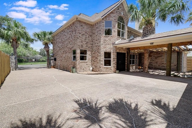 6302 Grandvilliers Dr, Corpus Christi, TX 78414 - rear view of property featuring brick siding and a patio area