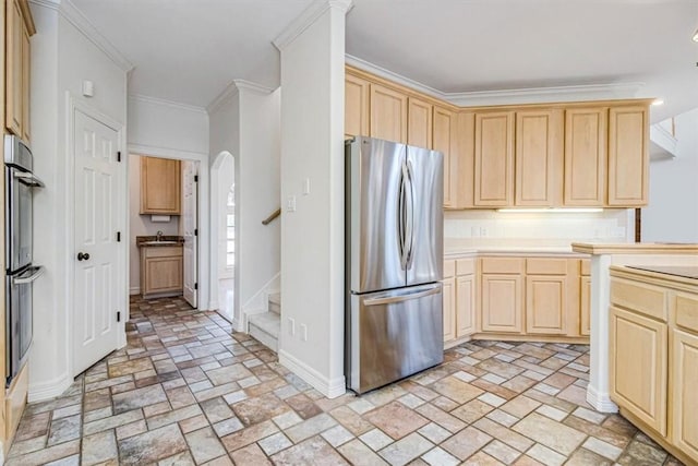 6302 Grandvilliers Dr, Corpus Christi, TX 78414 - kitchen featuring appliances with stainless steel finishes, light brown cabinets, ornamental molding, and arched walkways