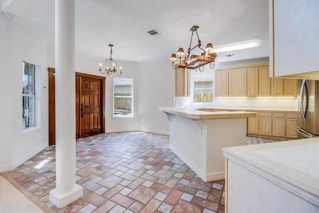 6302 Grandvilliers Dr, Corpus Christi, TX 78414 - kitchen featuring a chandelier, freestanding refrigerator, light brown cabinetry, tile counters, and a kitchen bar