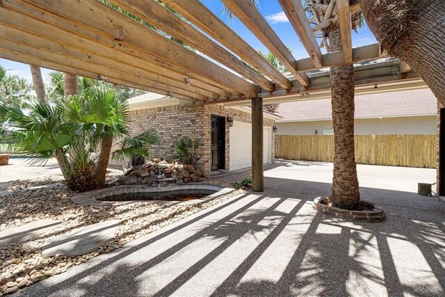 6302 Grandvilliers Dr, Corpus Christi, TX 78414 - view of patio / terrace featuring a pergola, a garage, and concrete driveway