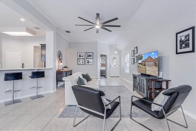 living room with light tile patterned floors, ceiling fan, visible vents, baseboards, and crown molding