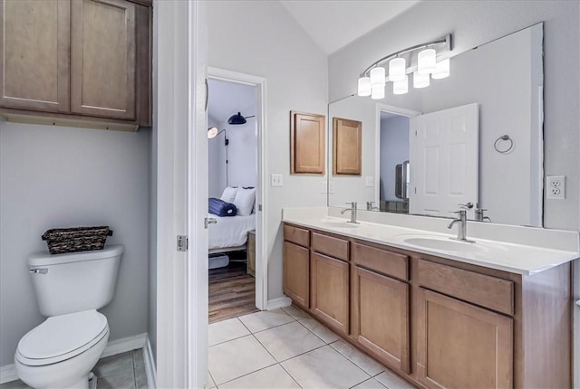 full bathroom with toilet, tile patterned flooring, ensuite bath, and a sink