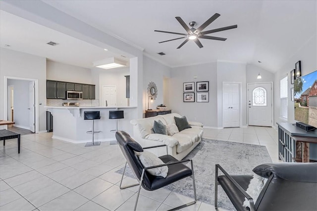 living area featuring lofted ceiling, light tile patterned floors, baseboards, and visible vents