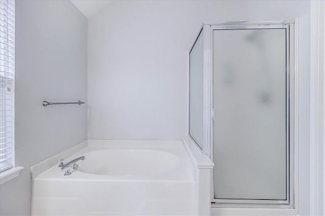 bathroom featuring a garden tub and a stall shower