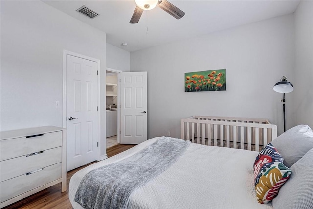 bedroom with ceiling fan, wood finished floors, and visible vents