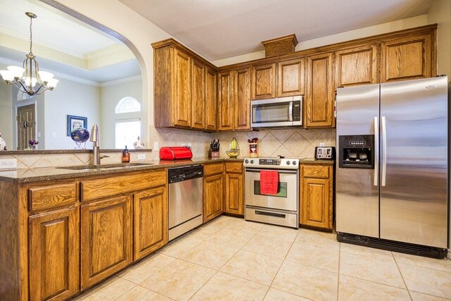 324 Nicklaus Dr, Portland, TX 78374 - kitchen with light tile patterned flooring, appliances with stainless steel finishes, sink, and backsplash