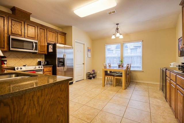 324 Nicklaus Dr, Portland, TX 78374 - kitchen with tasteful backsplash, pendant lighting, appliances with stainless steel finishes, and light tile patterned floors