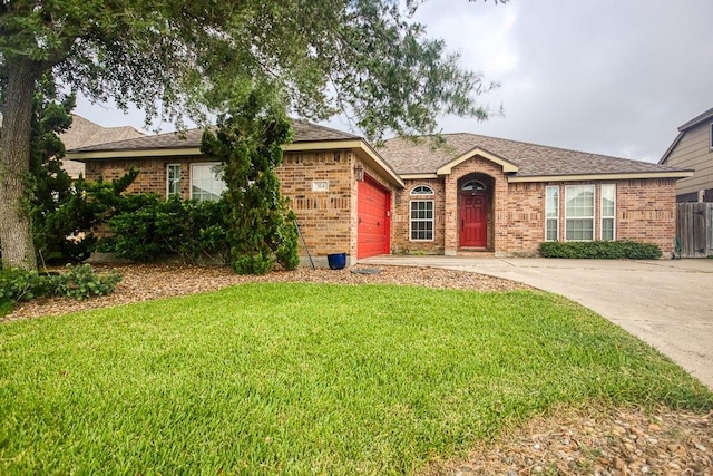 ranch-style home with a garage and a front lawn