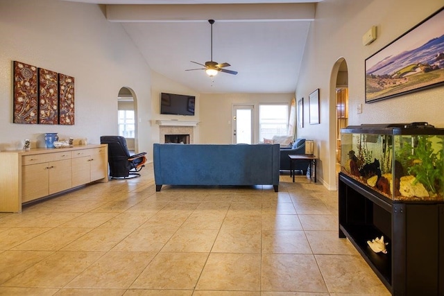 tiled living room featuring ceiling fan, a wealth of natural light, high vaulted ceiling, and beamed ceiling