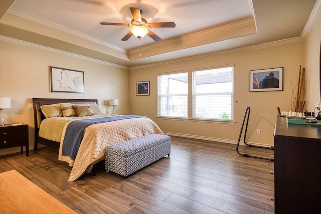324 Nicklaus Dr, Portland, TX 78374 - bedroom with crown molding, dark wood-type flooring, ceiling fan, and a tray ceiling