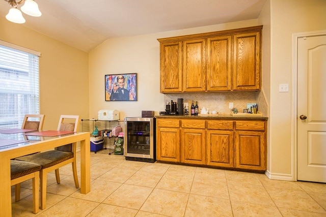 324 Nicklaus Dr, Portland, TX 78374 - kitchen featuring wine cooler, light tile patterned floors, decorative backsplash, and lofted ceiling
