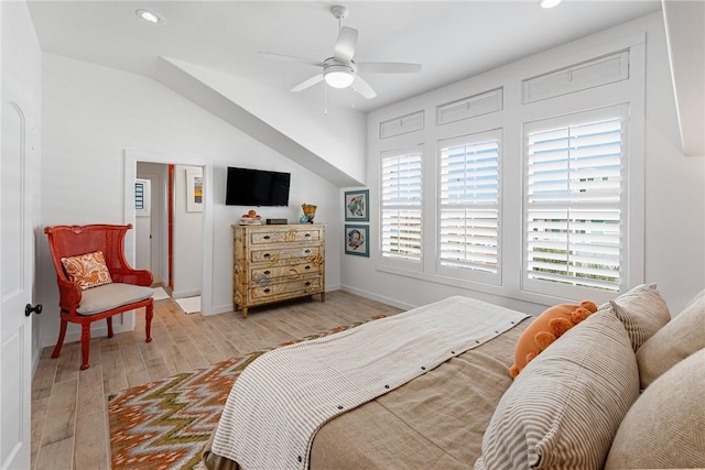 bedroom with light hardwood / wood-style flooring, ceiling fan, and lofted ceiling