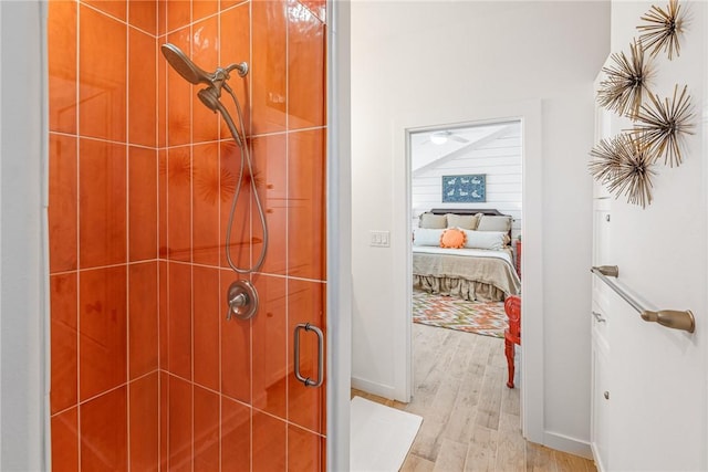 bathroom with an enclosed shower and wood-type flooring