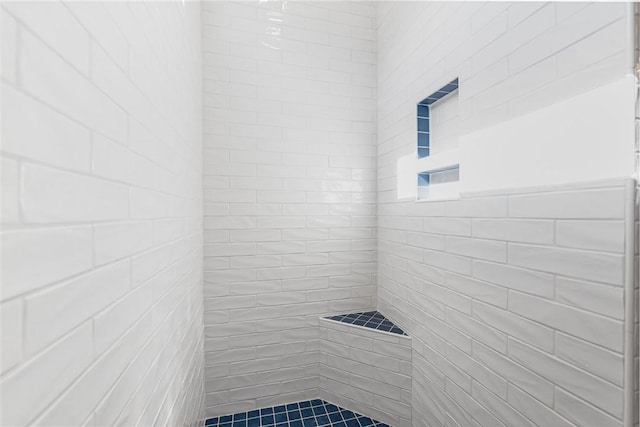 bathroom with a tile shower