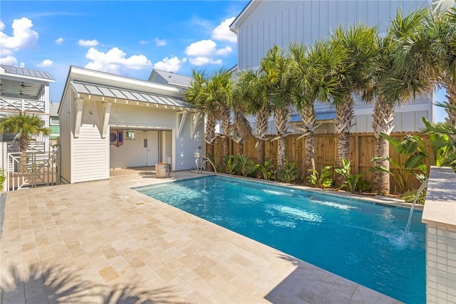 view of pool with pool water feature and a patio