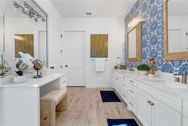 bathroom with hardwood / wood-style floors and vanity