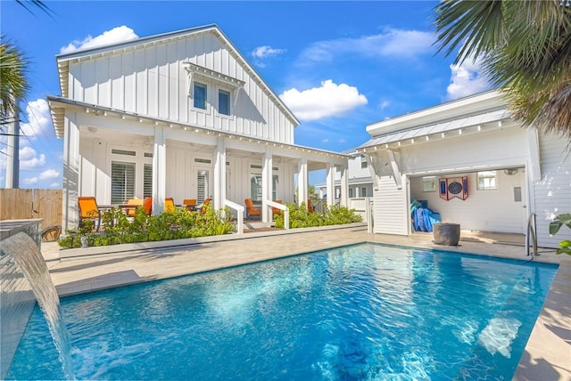 back of house featuring pool water feature, a fenced in pool, and a patio area