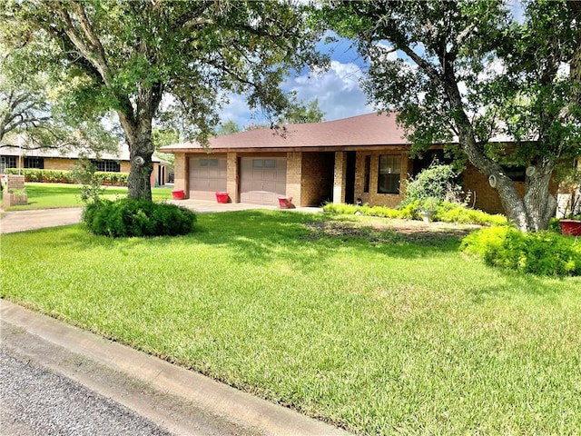 single story home featuring a garage and a front yard