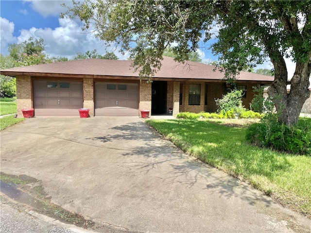 ranch-style home with a garage and a front yard