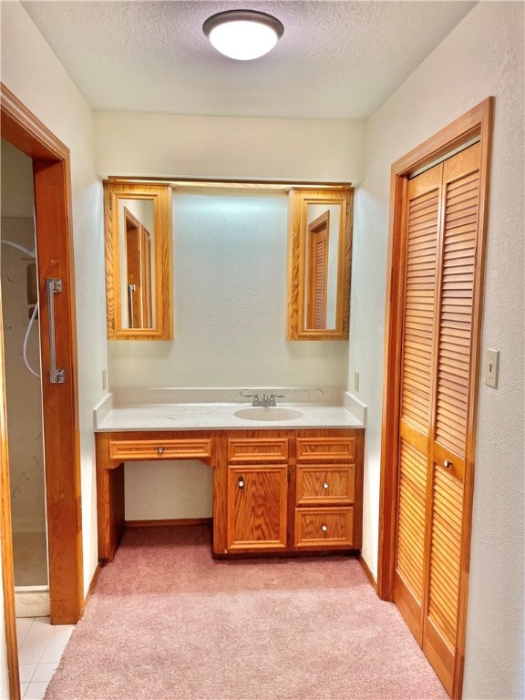 bathroom featuring vanity and a textured ceiling