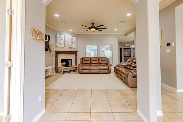 living area with ceiling fan, visible vents, crown molding, and light tile patterned floors