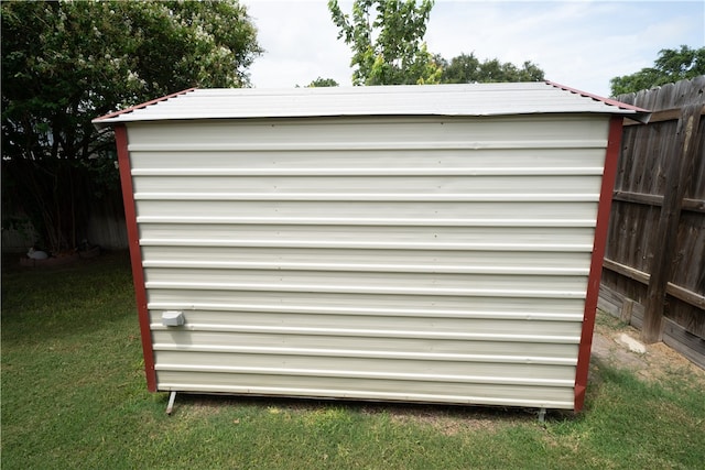 view of outbuilding featuring a lawn