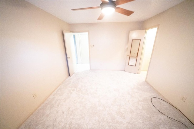 spare room featuring carpet flooring and ceiling fan