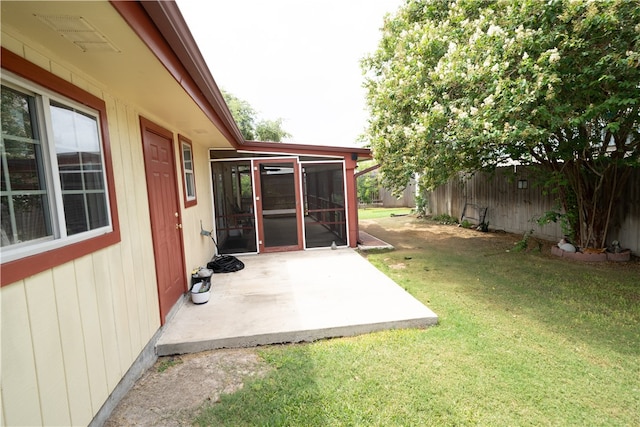 view of yard with a sunroom and a patio area